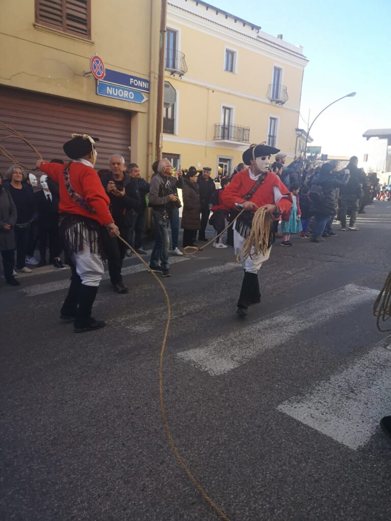 Durante la sflilata gli Issohadores vestiti con giubba rossa, pantaloni bianchi e fazzoletto nella vita tengono la fune.